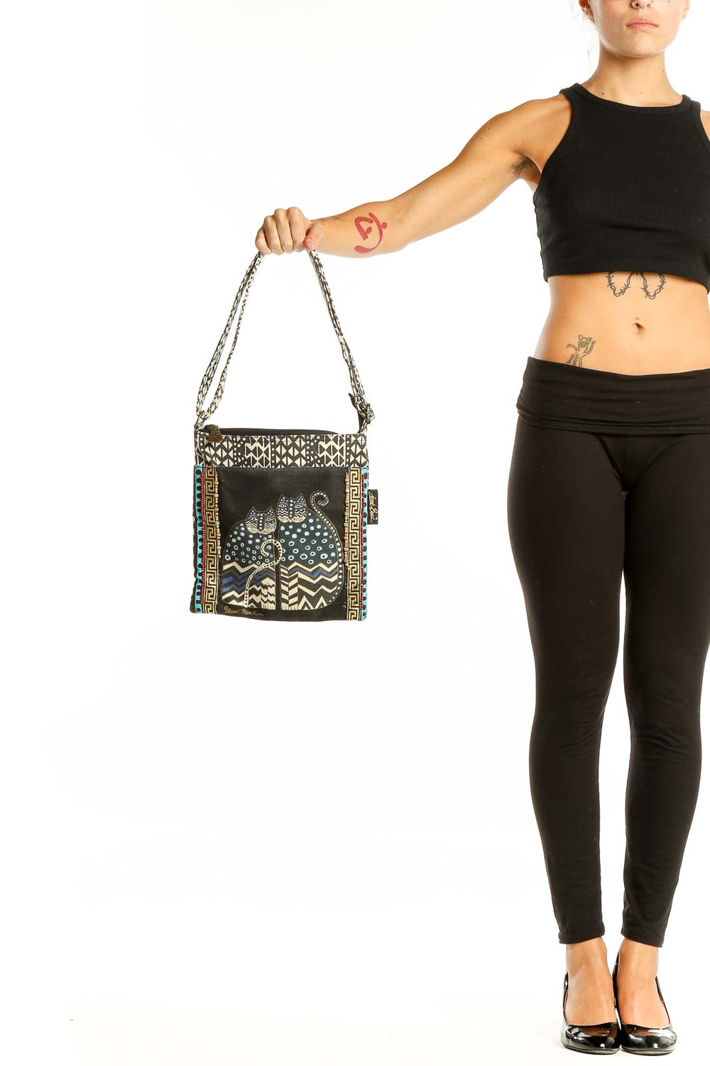 Front view of Laurel Burch black and white patterned cat shoulder bag with chain straps