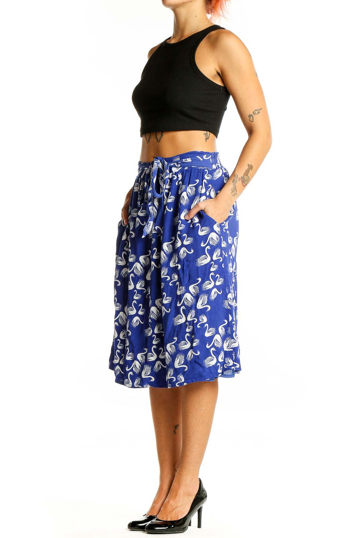 Front view of blue midi skirt with white swan print and elastic waistband