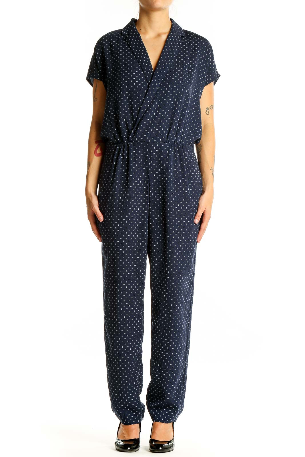 Front view of J.Crew navy polka dot jumpsuit with wrap-style V-neckline