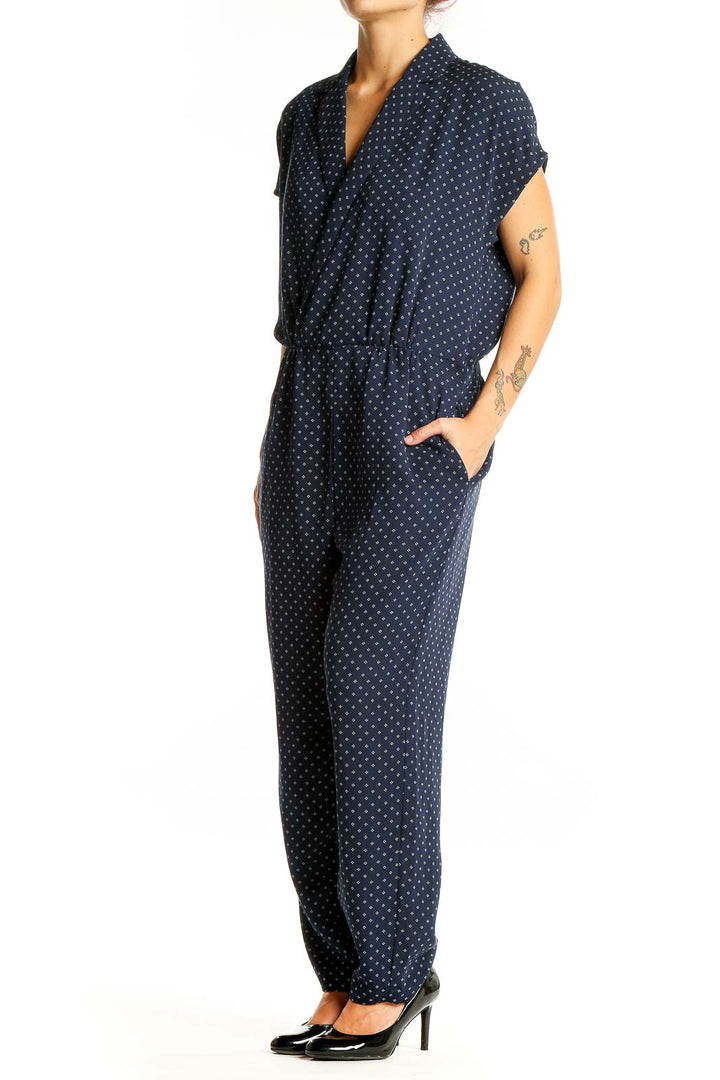 Front view of J.Crew navy polka dot jumpsuit with wrap-style V-neckline