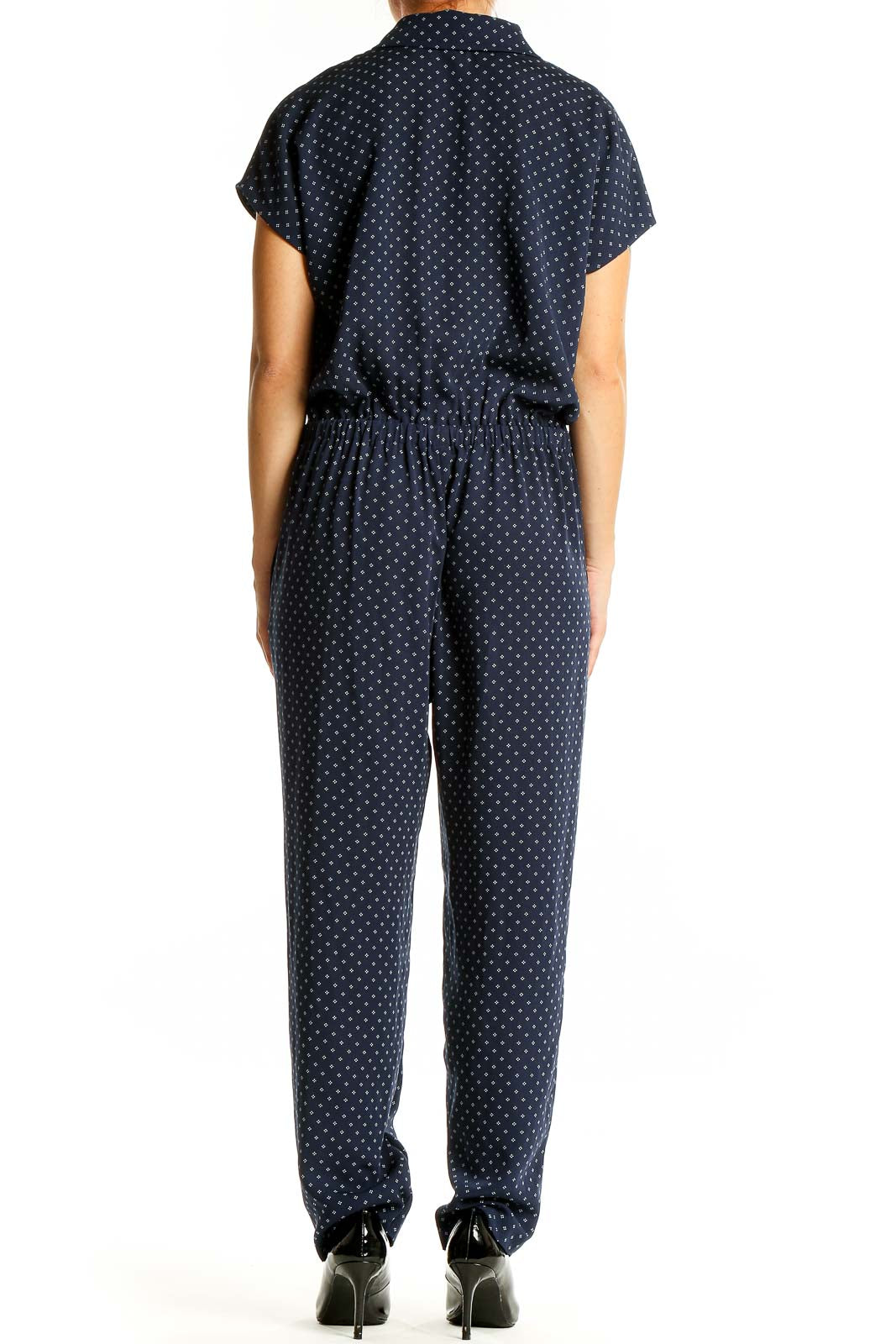 Back view of J.Crew navy polka dot jumpsuit showing relaxed fit and full-length pants