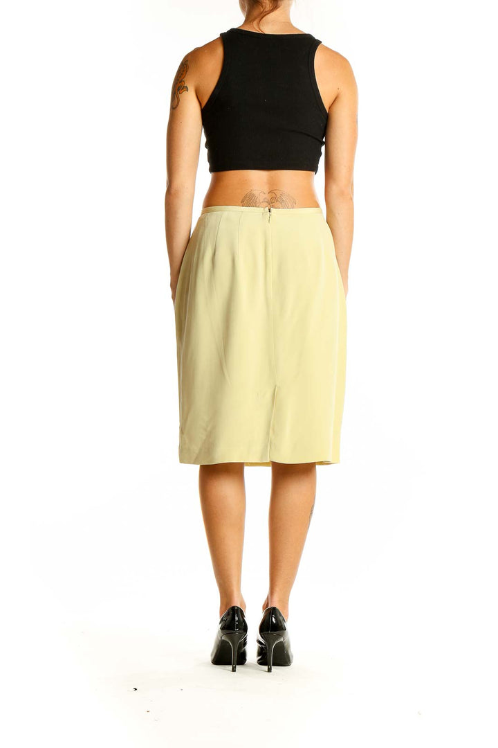 Back view of pale yellow Casual Corner pencil skirt with black crop top