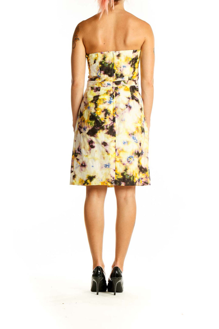 Back view of J.Crew yellow floral strapless cocktail dress showing A-line skirt