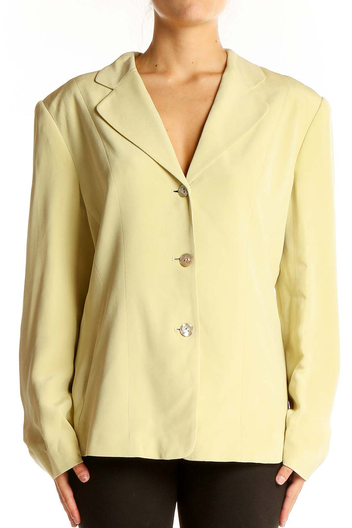 Front view of yellow Casual Corner blazer with three-button closure