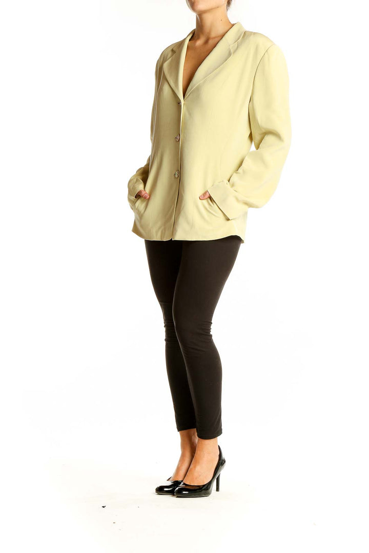 Front view of yellow Casual Corner blazer with three-button closure