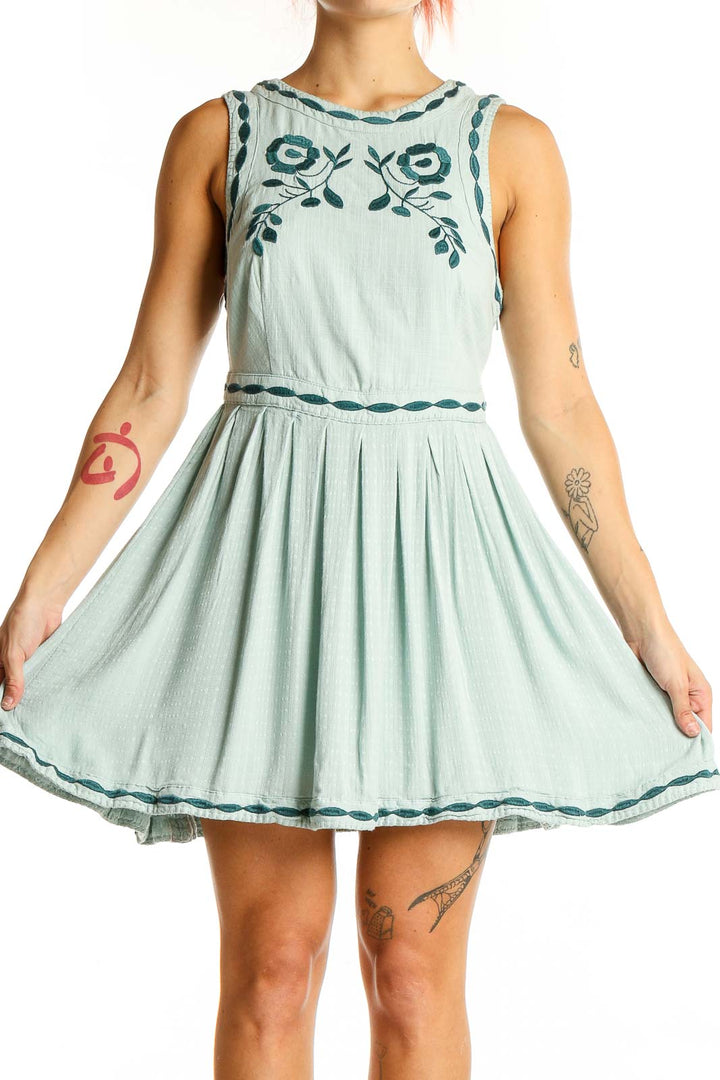 Front view of Free People mint mini dress with teal floral embroidery