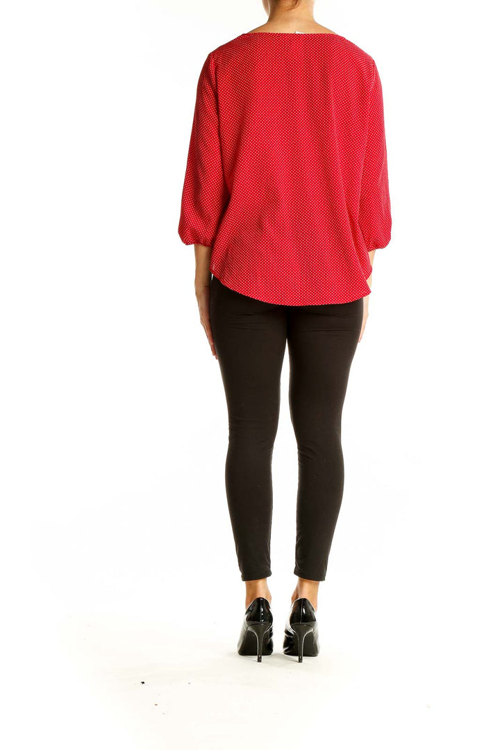 Back view of LE LIS red polka dot blouse showing relaxed fit