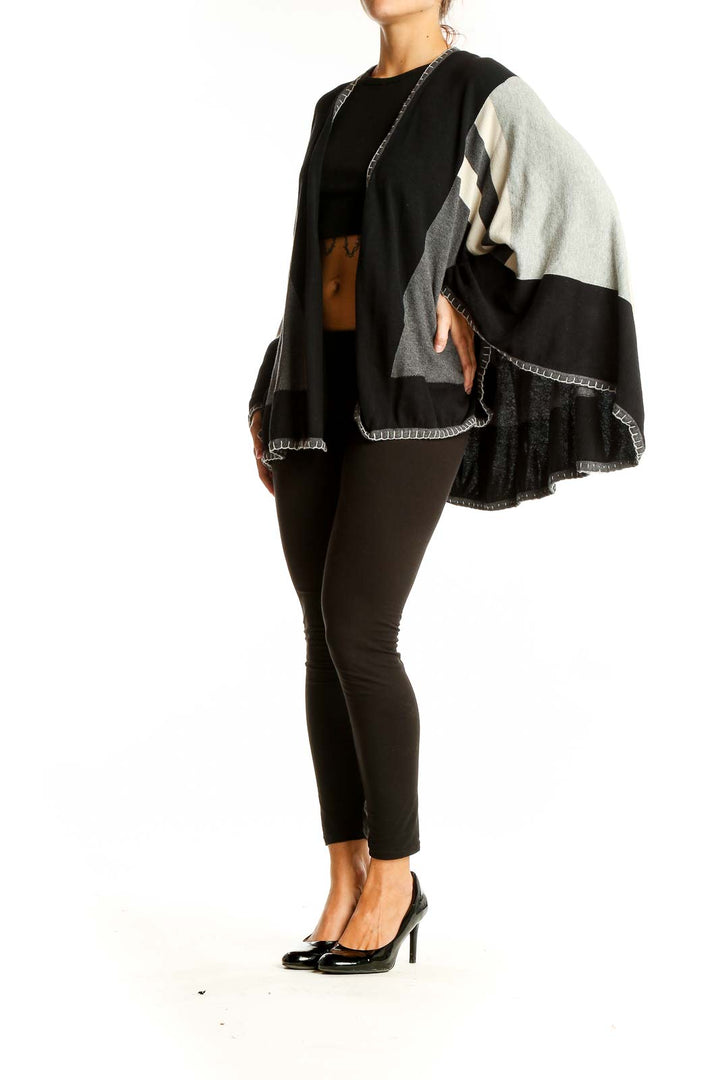 Front view of Cabi Black and Gray Geometric Knit Poncho on model