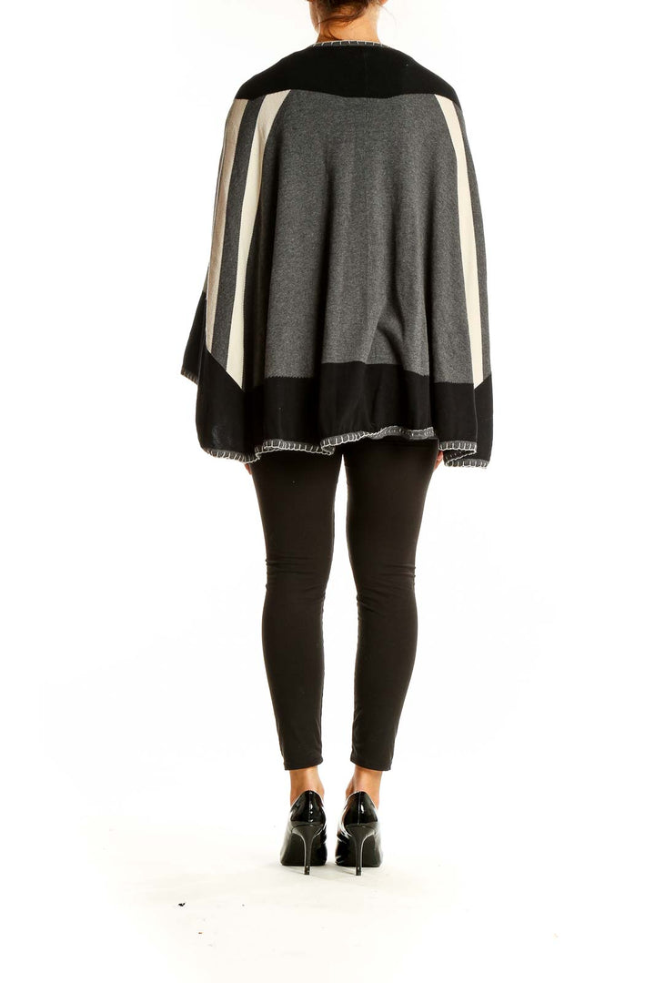 Back view of Cabi Black and Gray Geometric Knit Poncho on model