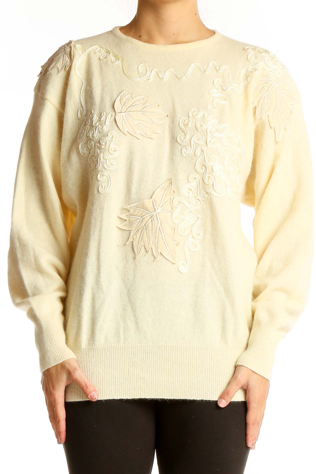 Front view of cream embroidered luxury knit sweater with leaf patterns