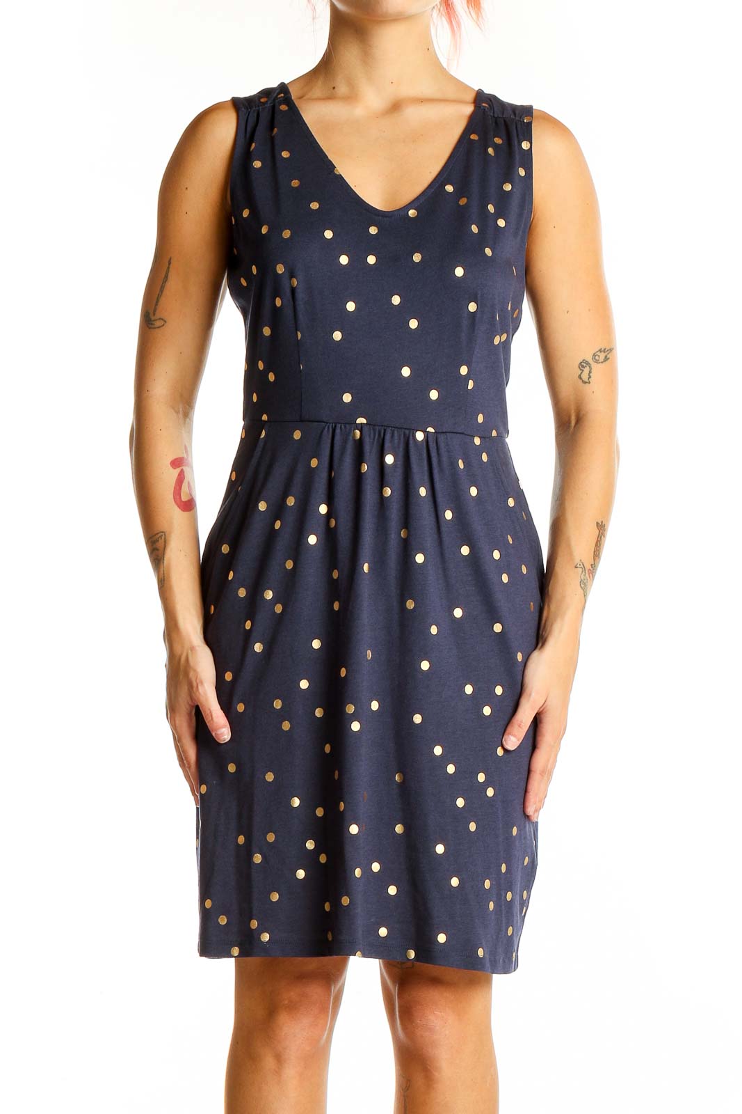 Front view of Boden navy dress with gold polka dots, sleeveless design