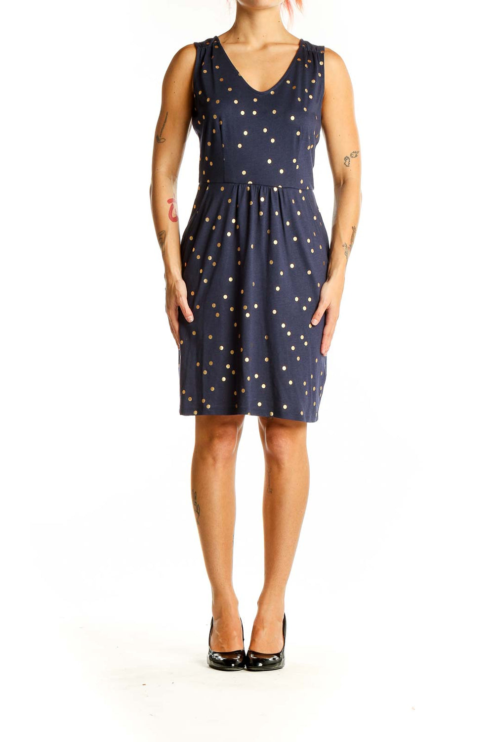 Front view of Boden navy dress with gold polka dots, sleeveless design