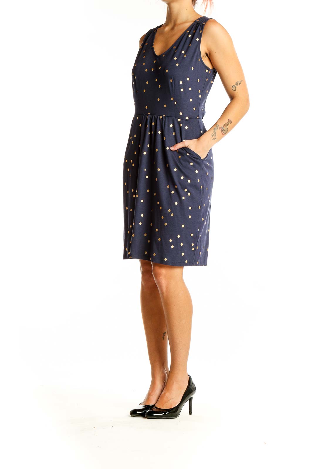 Front view of Boden navy dress with gold polka dots, sleeveless design