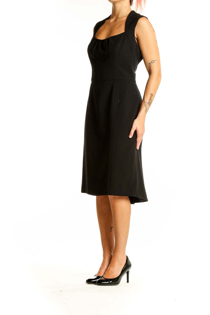 Front view of black sleeveless midi dress with square neckline