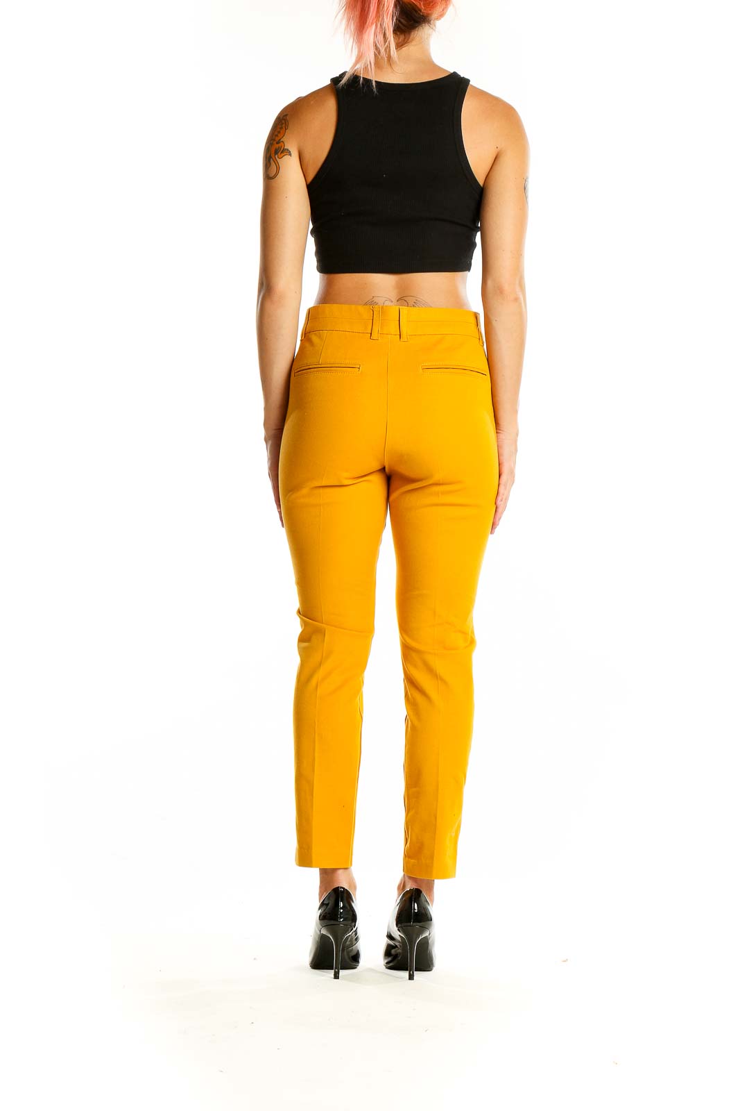 Back view of Gap yellow slim-fit trousers on model