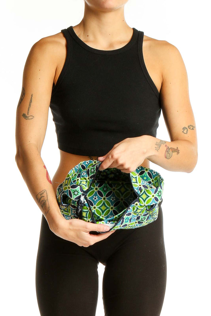 Person holding Vera Bradley green geometric print shoulder bag