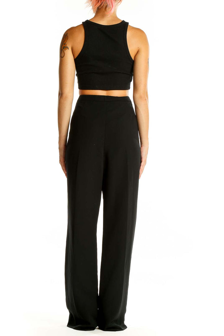 Back view of model wearing Tahari Arthur S. Levine black wide-leg dress pants with crop top