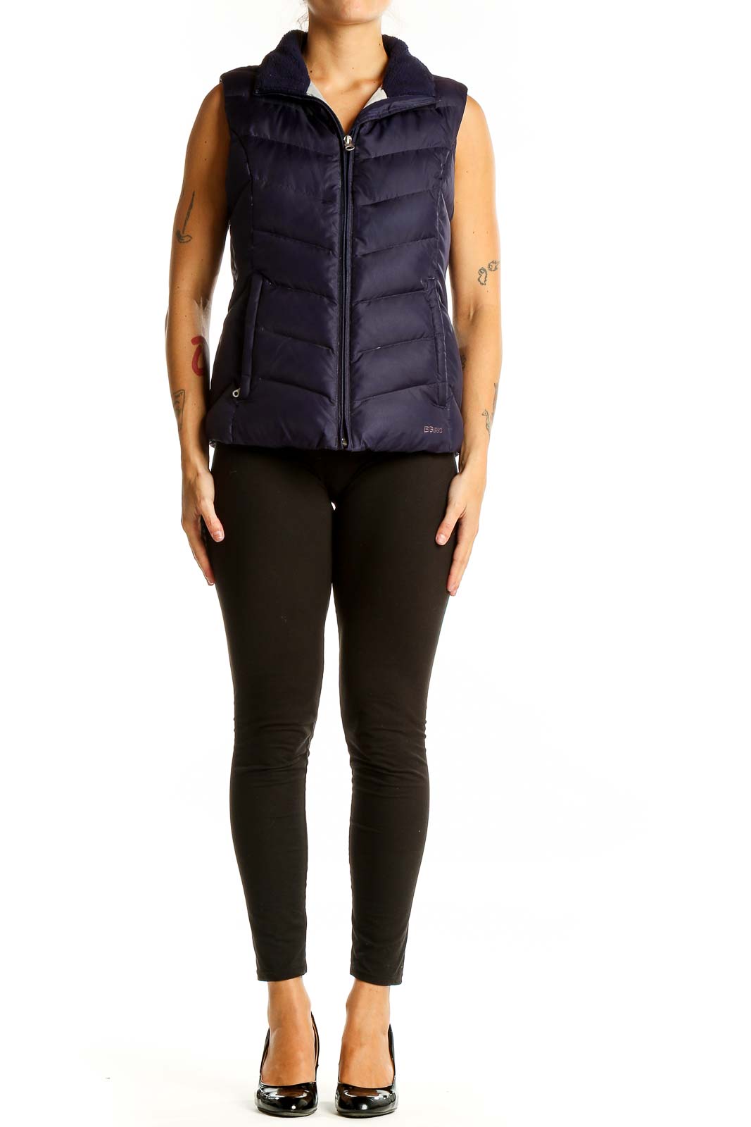 Front view of Eddie Bauer navy quilted down puffer vest on model