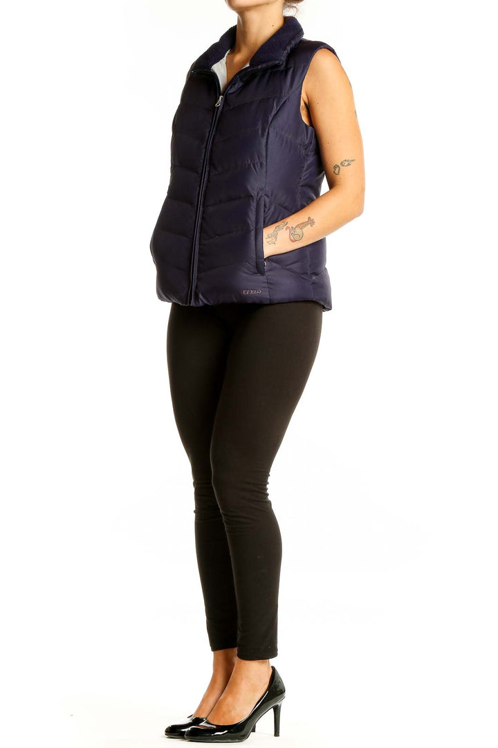 Front view of Eddie Bauer navy quilted down puffer vest on model