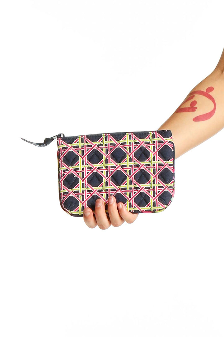 Front view of Vera Bradley black clutch with pink and yellow geometric pattern