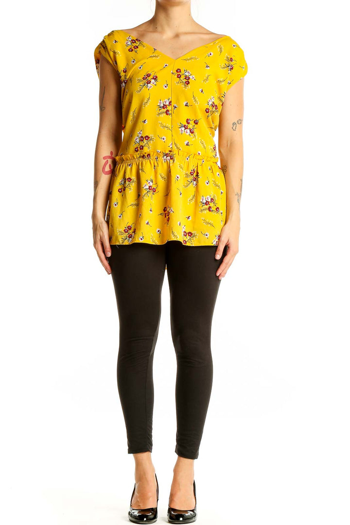 Front view of LOFT yellow floral peplum blouse with cap sleeves and V-neckline