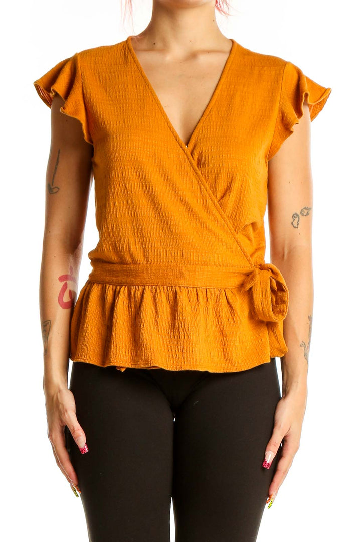 Front view of orange wrap-style peplum top with flutter sleeves