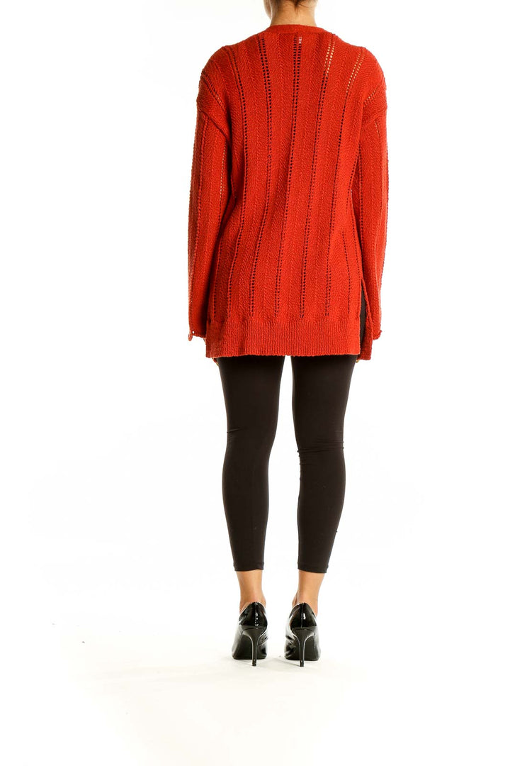 Back view of red knit open-front cardigan showing ribbed texture