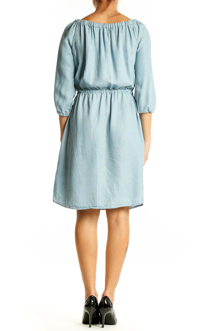 Back view of light blue Lyocell dress showing gathered waist and 3/4 length sleeves