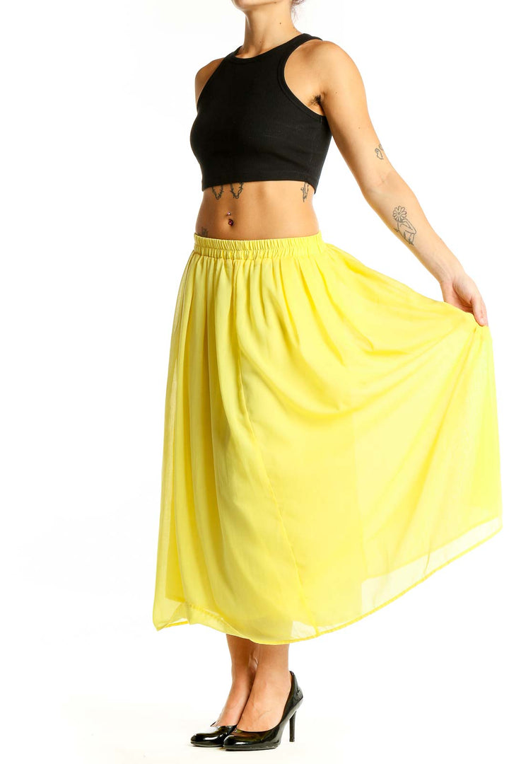 Front view of yellow flowy midi skirt by Sonny Lable