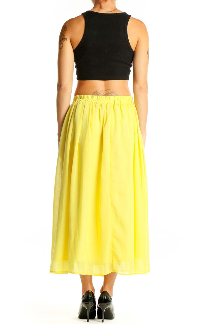 Back view of yellow flowy midi skirt by Sonny Lable