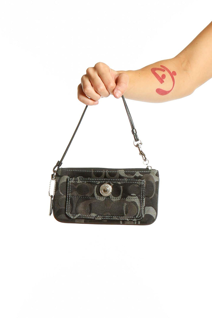 Front view of Coach black signature print wristlet clutch with wrist strap