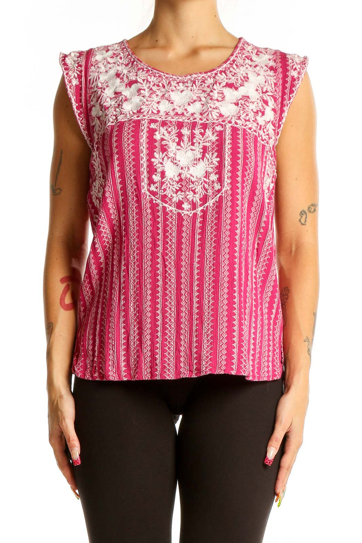 Front view of pink sleeveless top with white floral embroidery and vertical stripes