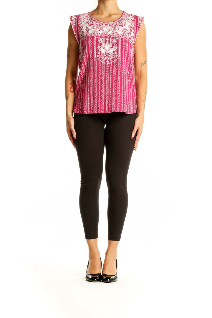 Front view of pink sleeveless top with white floral embroidery and vertical stripes