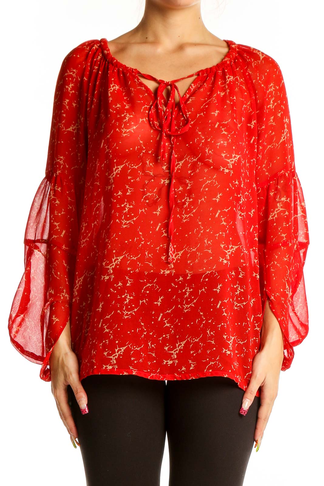 Front view of red sheer peasant blouse with golden floral print and tie neckline