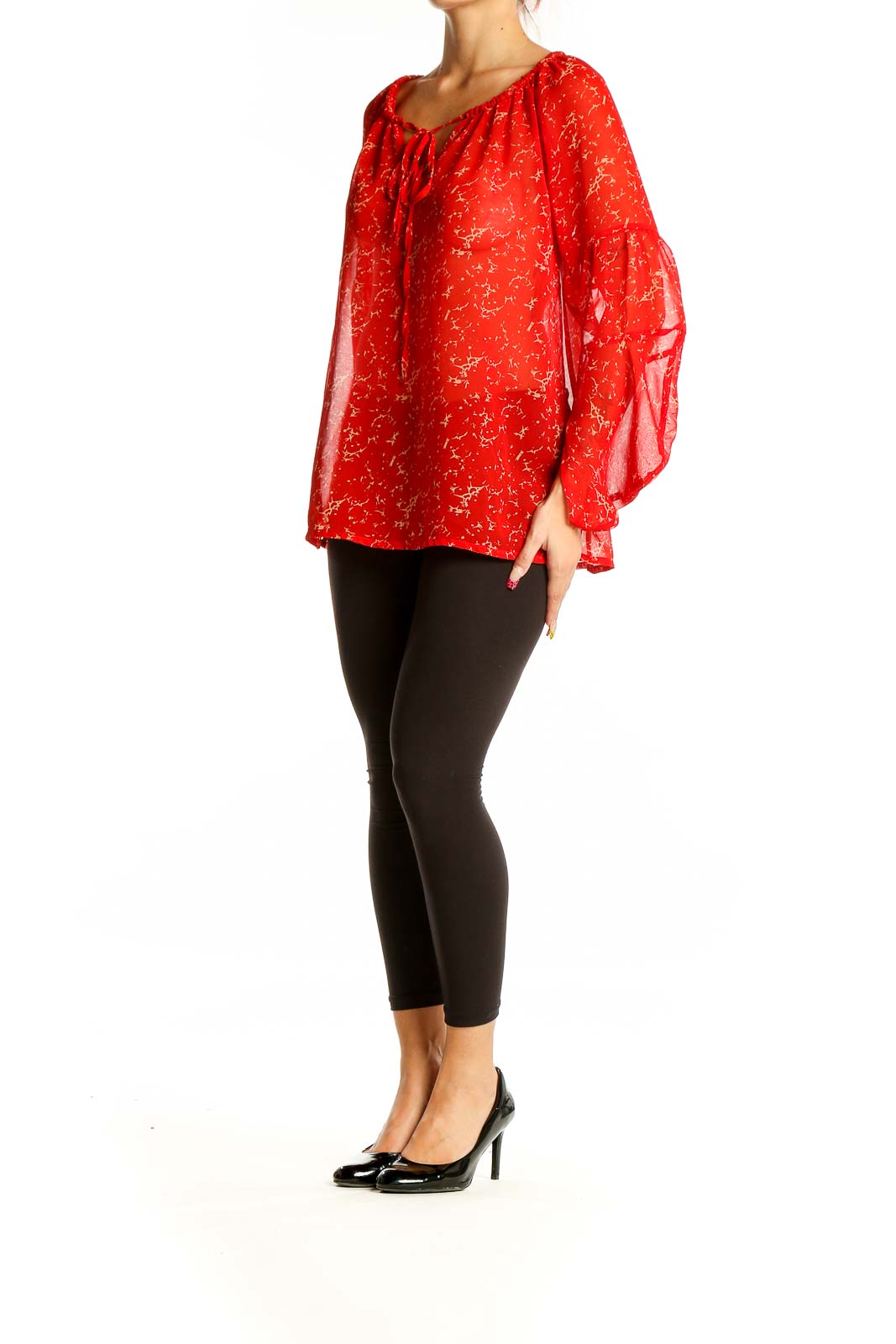 Front view of red sheer peasant blouse with golden floral print and tie neckline