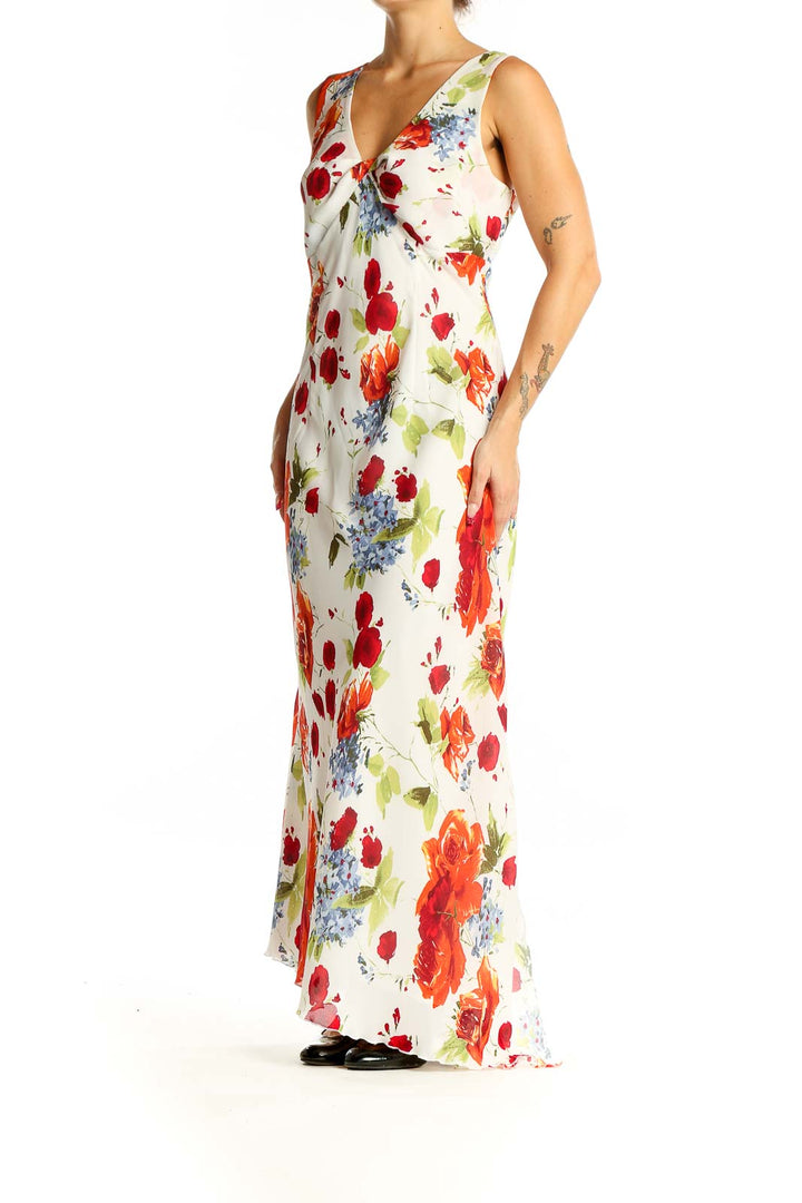 Front view of Tribal white floral maxi dress with red, orange, and blue flowers