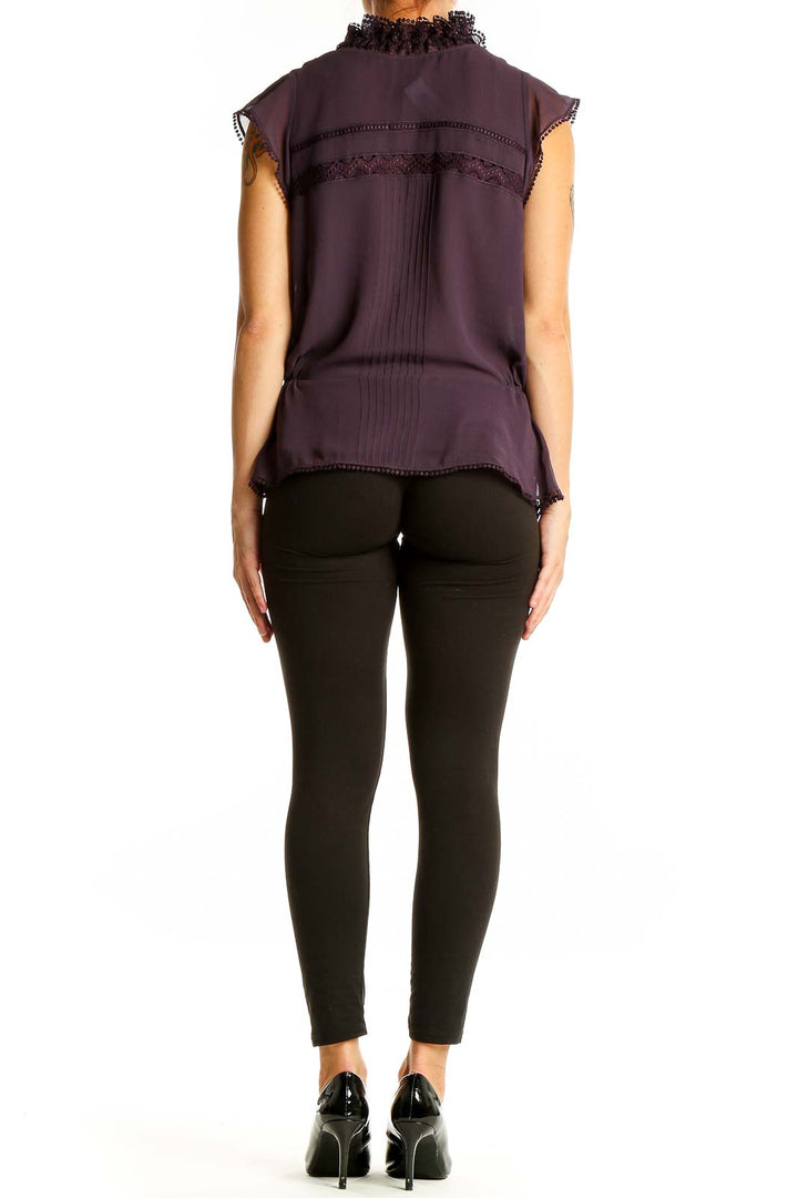 Back view of purple sleeveless blouse showing lace-trimmed cap sleeves