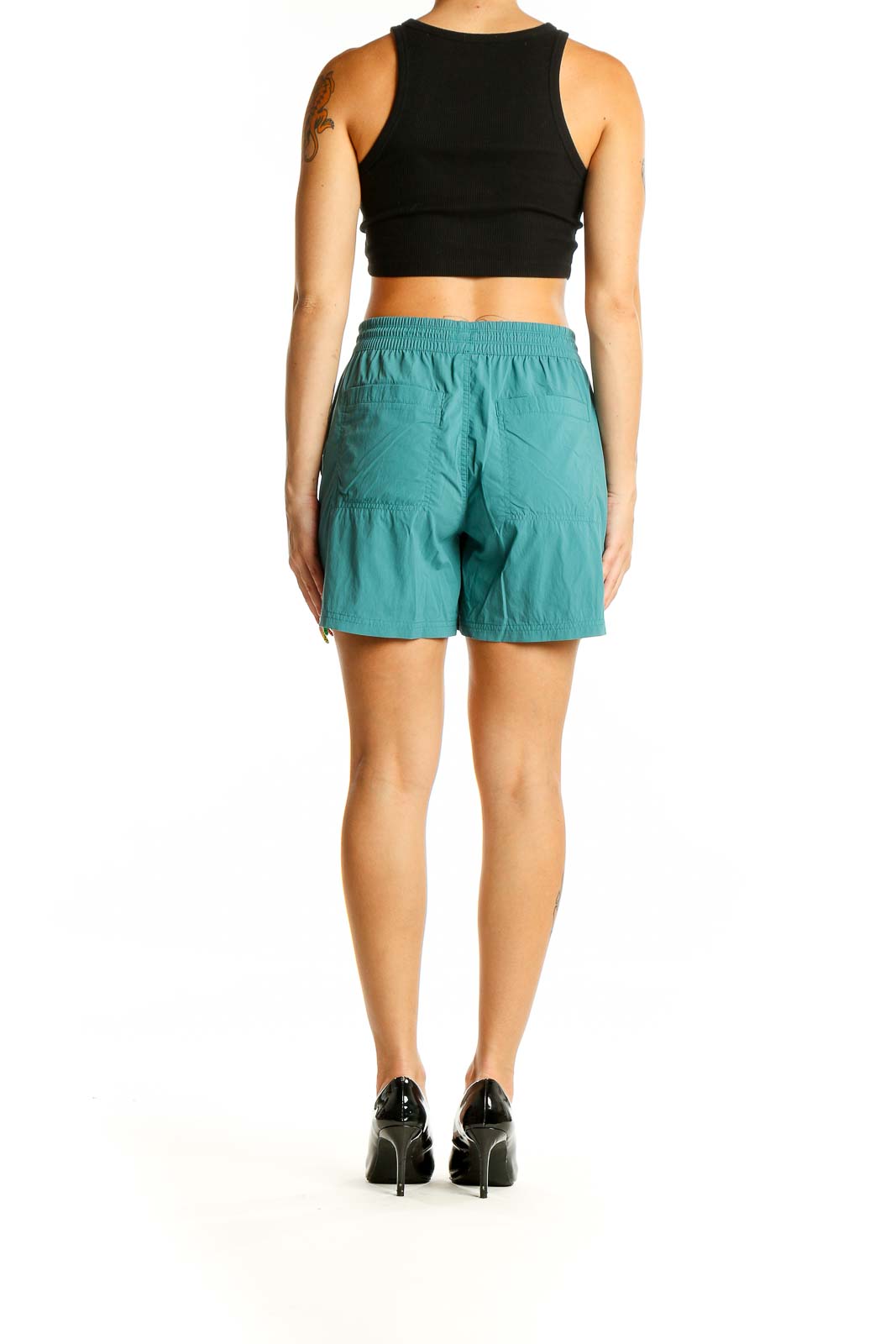 Back view of teal REI COOP activewear shorts on model