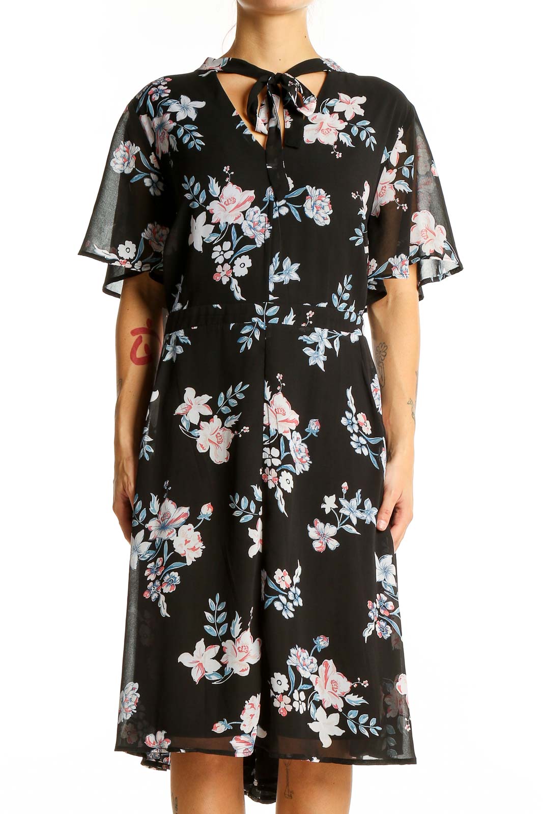 Front view of Torrid black floral midi dress with flutter sleeves and tie-neck detail