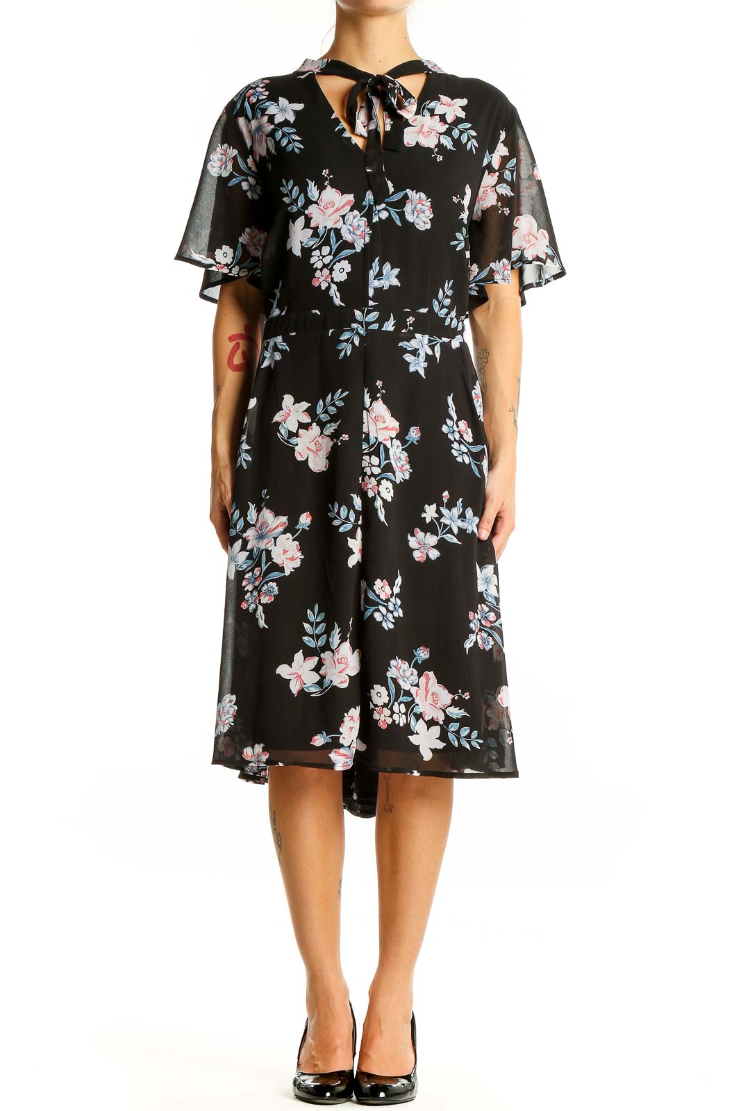 Front view of Torrid black floral midi dress with flutter sleeves and tie-neck detail