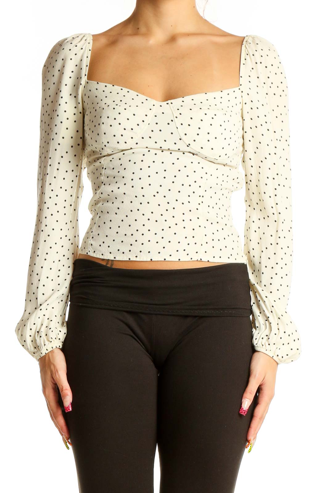 Front view of Reformation cream polka dot crop top with puff sleeves