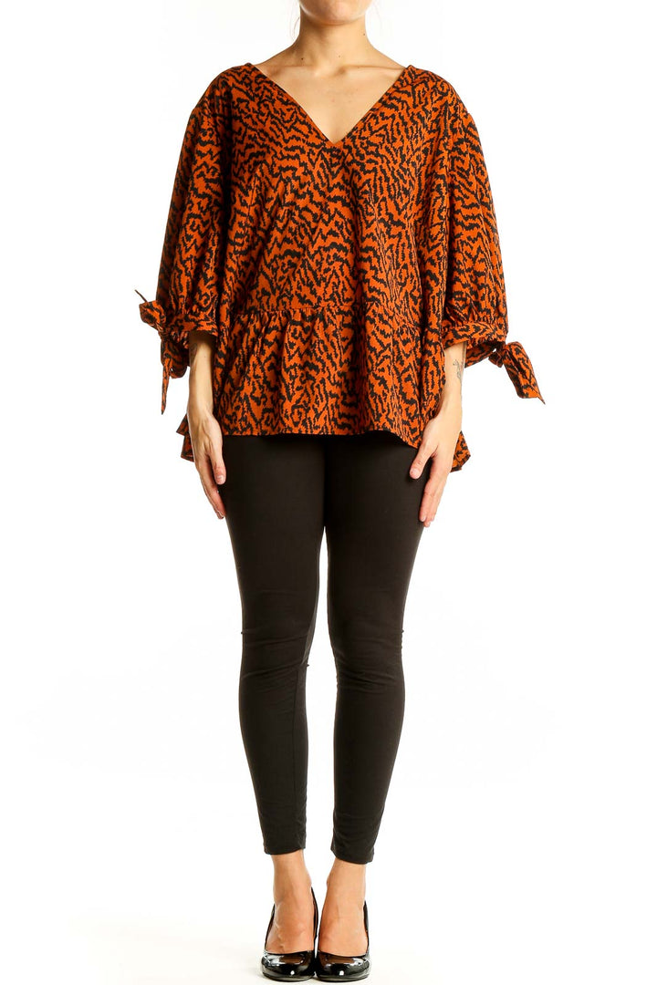 Front view of Eloquii orange abstract print V-neck blouse with tie sleeves