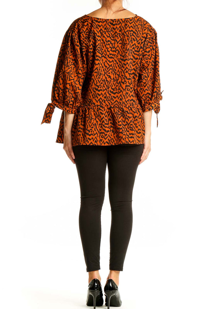 Back view of Eloquii orange abstract print blouse showing peplum waist