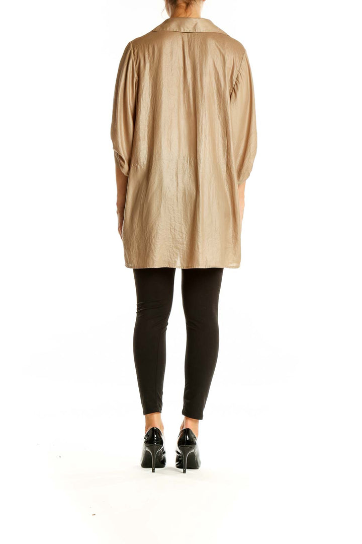 Back view of BCBG MaxAzria beige oversized button-down blouse showing high-low hemline