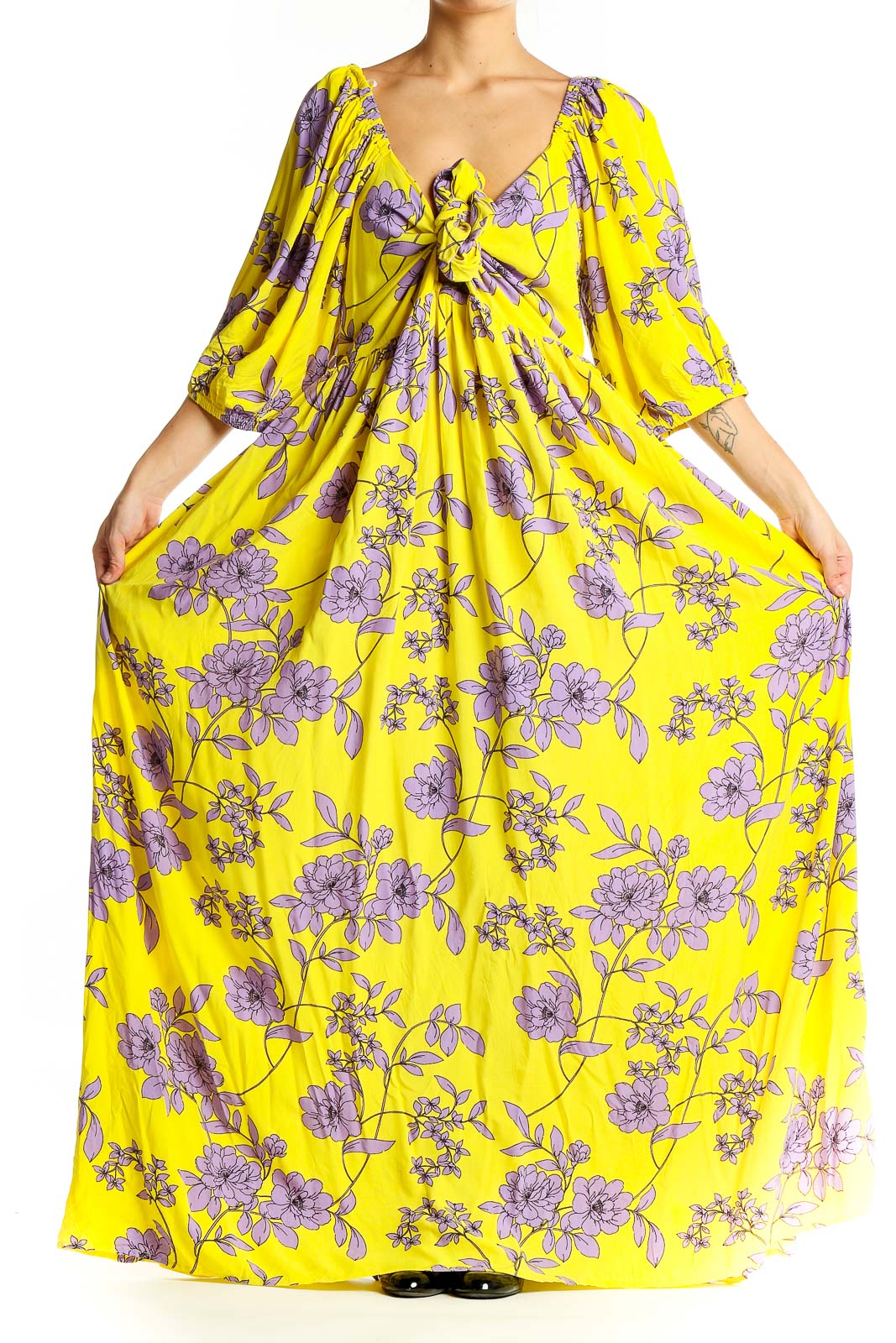 Front view of yellow floral maxi dress with V-neck and tie detail