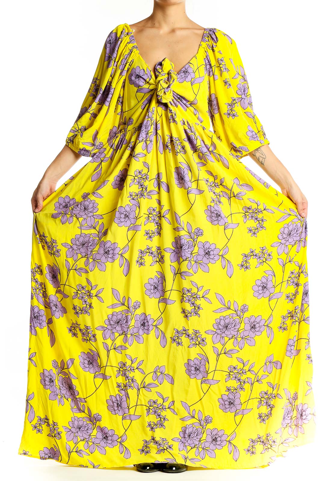 Front view of yellow floral maxi dress with V-neck and tie detail