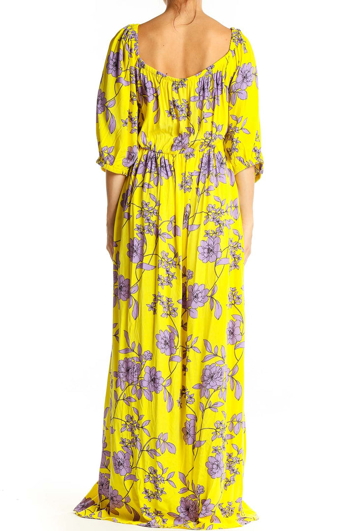 Back view of yellow floral maxi dress showing flowing silhouette