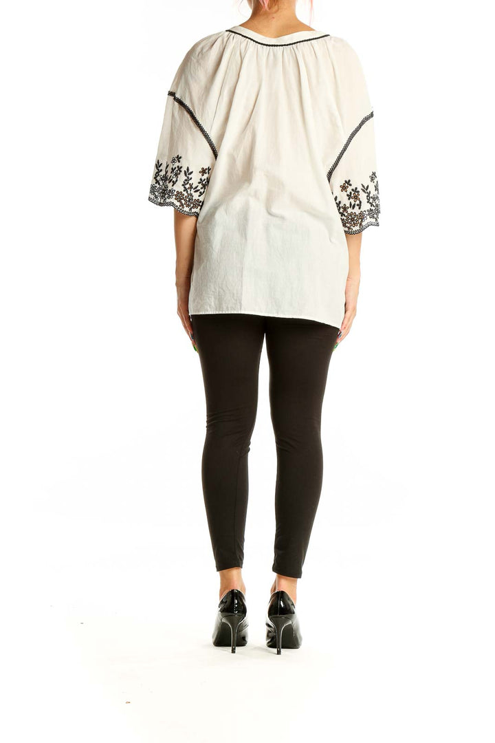 Back view of Zara white embroidered cotton peasant top showing bell sleeves