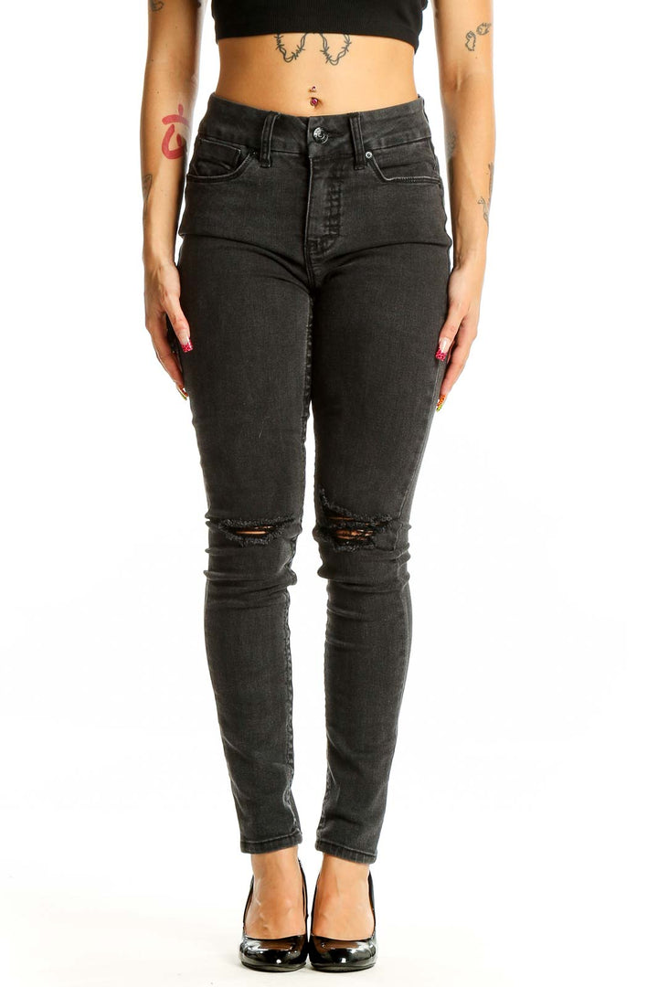 Front view of Seven7 black distressed skinny jeans on model