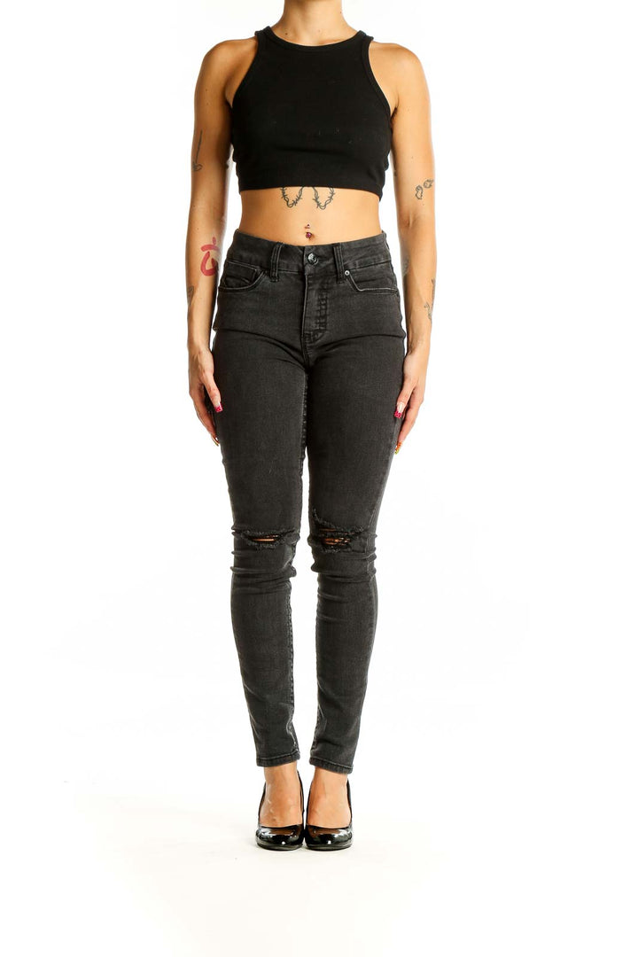 Front view of Seven7 black distressed skinny jeans on model